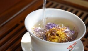 Water cascades over vibrant floral tea blossoms