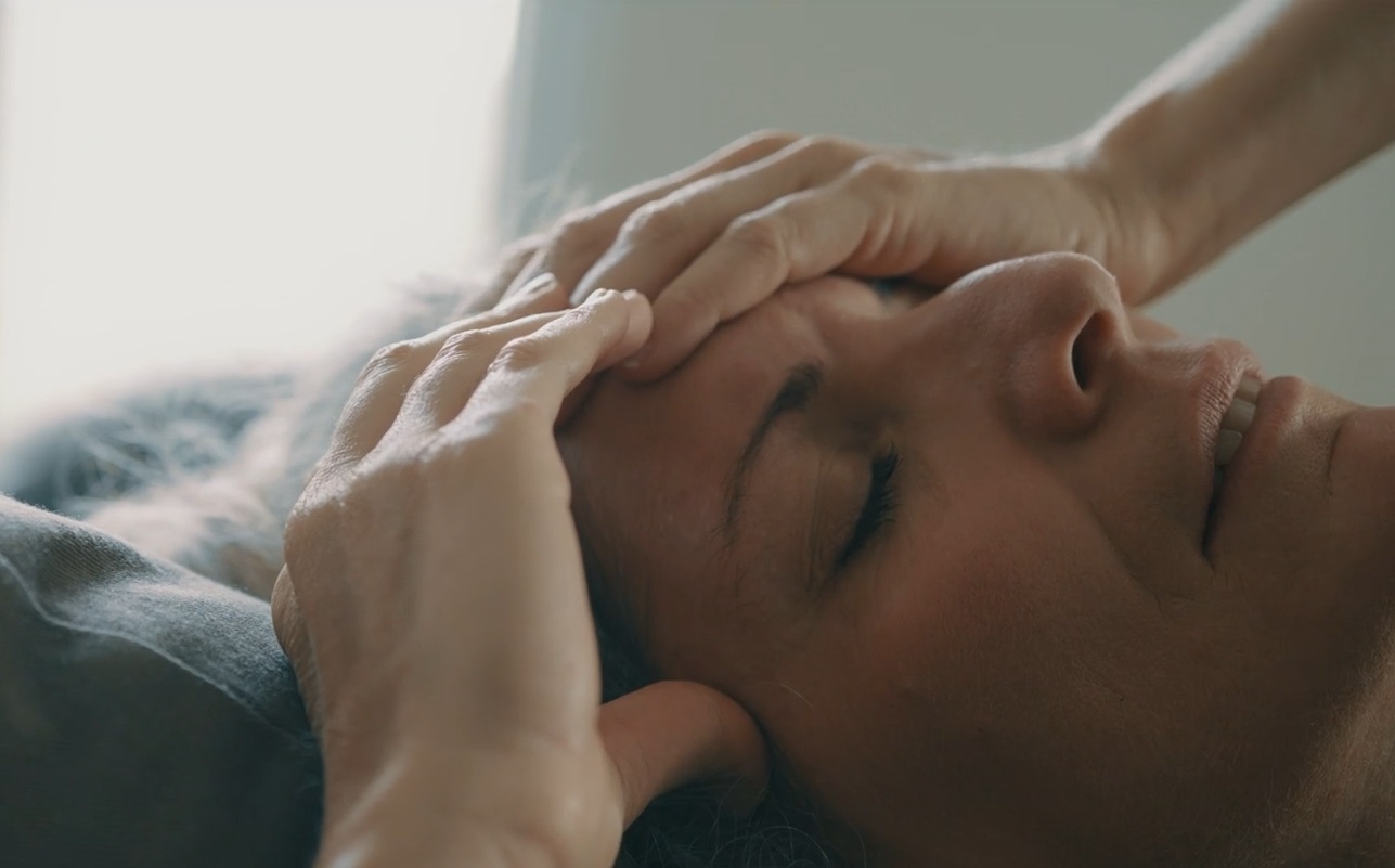 The woman is holding her head because she is stressed